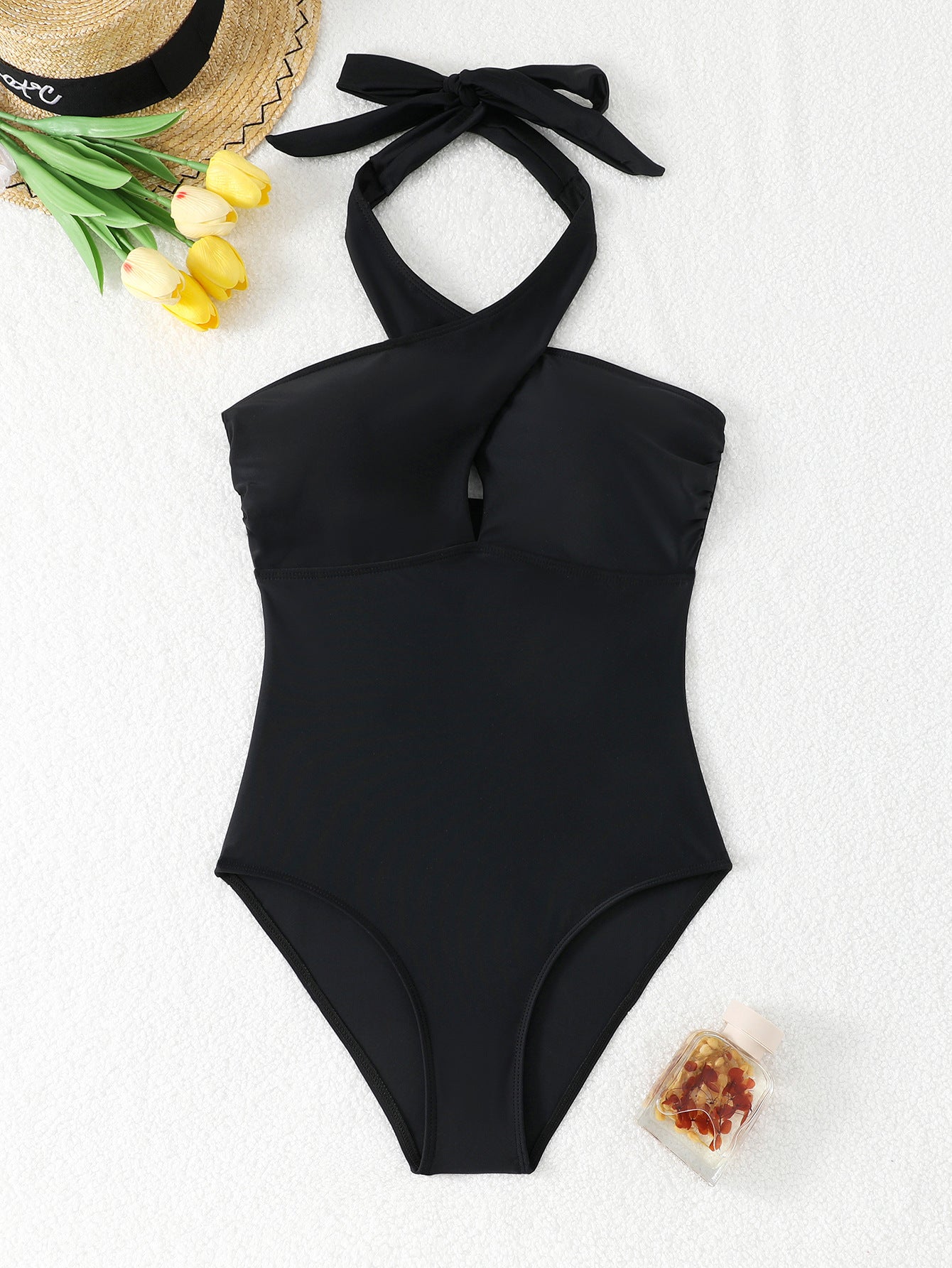 Black one-piece swimsuit with tight cross neck strap and exposed back